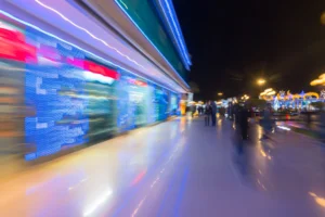 A bustling street with colourful lights.