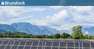 A beautiful Swiss landscape with solar farm in the foreground