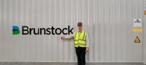 Daniel Tragai, standing in front of one of the Monarto BESS energy storage containers at the Brunstock factory.